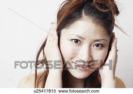 Stock Photography - Portrait of a young woman listening to music. Fotosearch