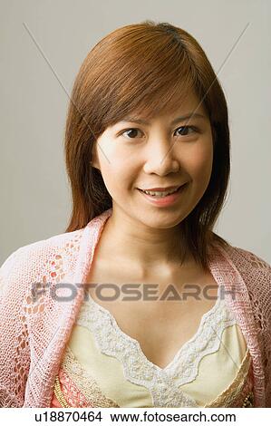 Portrait of a young woman smiling View Large Photo Image Picture - Portrait of a young woman smiling. Fotosearch