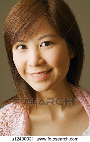 Portrait of a young woman smiling View Large Photo Image Stock Image - Portrait of a young woman smiling. Fotosearch