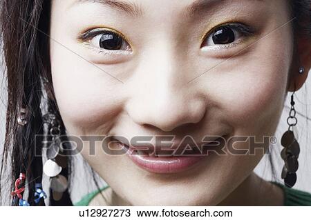 Stock Image - Portrait of a young woman smiling. Fotosearch