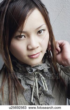 Stock Image - Portrait of a young woman smiling. Fotosearch