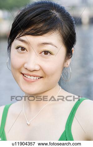 Portrait of a young woman smiling View Large Photo Image Stock Photo - Portrait of a young woman smiling. Fotosearch