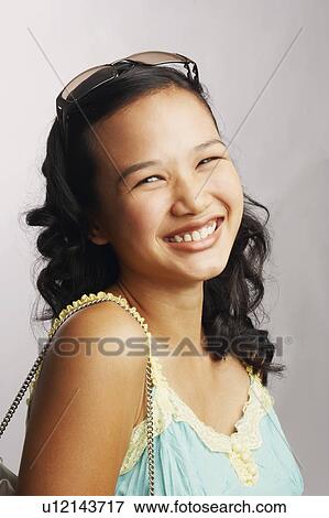 Stock Photo - Portrait of a young woman smiling. Fotosearch