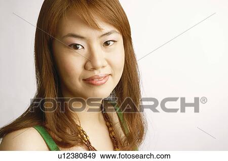 Portrait of a young woman smiling View Large Photo Image Stock Photo - Portrait of a young woman smiling. Fotosearch