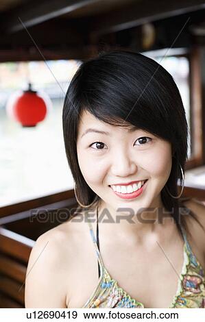Portrait of a young woman smiling View Large Photo Image Stock Photo - Portrait of a young woman smiling. Fotosearch