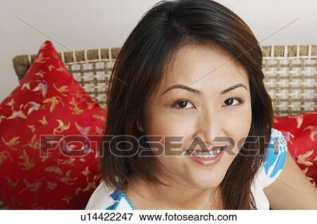 Portrait of a young woman smiling View Large Photo Image Stock Photo - Portrait of a young woman smiling. Fotosearch
