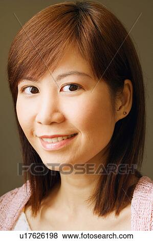 Stock Photo - Portrait of a young woman smiling. Fotosearch