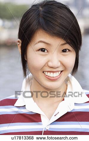 Stock Photo - Portrait of a young woman smiling. Fotosearch