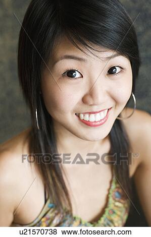 Stock Photo - Portrait of a young woman smiling. Fotosearch