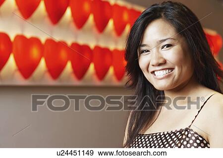 Stock Photo - Portrait of a young woman smiling. Fotosearch