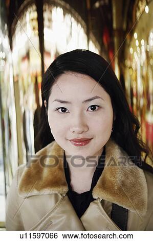 Portrait of a young woman smiling View Large Photo Image Stock Photograph - Portrait of a young woman smiling. Fotosearch