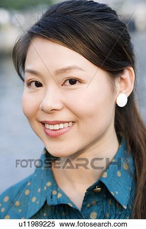 Stock Photography - Portrait of a young woman smiling. Fotosearch