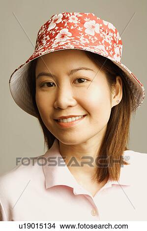 Picture - Portrait of a young woman wearing a hat. Fotosearch