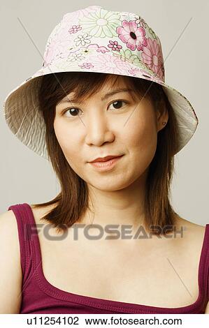 Portrait of a young woman wearing a hat View Large Photo Image Stock Image - Portrait of a young woman wearing a hat. Fotosearch