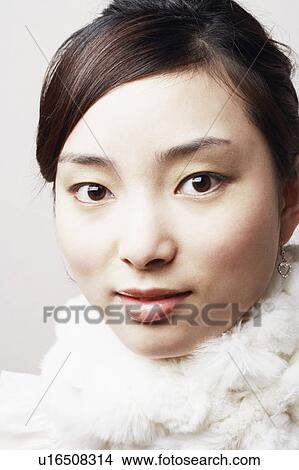 Portrait of a young woman with a feather boa around her neck View Large Photo Image Picture - Portrait of a young woman with a feather boa around her neck. Fotosearch