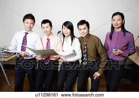Portrait of five business executives standing and smiling together View Large Photo Image Stock Image - Portrait of five business executives standing and smiling together. Fotosearch