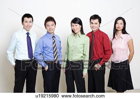 Stock Image - Portrait of five business executives standing together and smiling. Fotosearch
