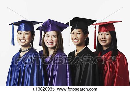 Stock Photography - Portrait of four female graduates standing in a row. Fotosearch