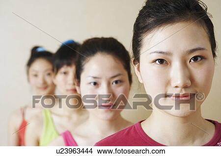 Picture - Portrait of four young women in a row. Fotosearch