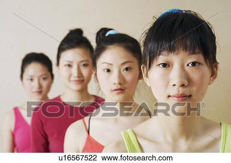 Stock Image - Portrait of four young women in a row. Fotosearch