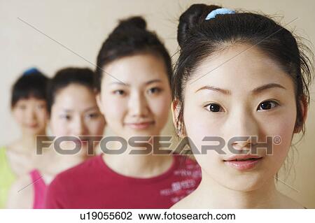 Stock Image - Portrait of four young women in a row. Fotosearch