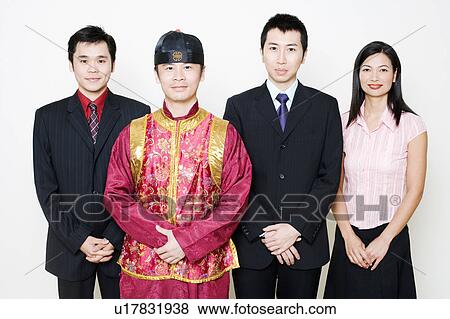 Stock Photo - Portrait of three business executives and a young man standing together. Fotosearch