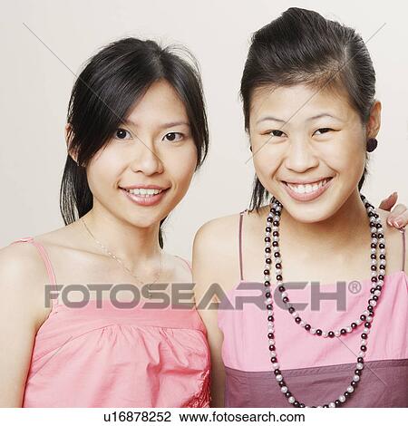 Stock Image - Portrait of three young women smiling. Fotosearch