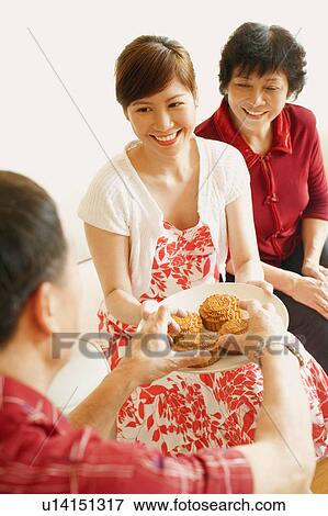 Senior man picking cake and young woman holding a plate View Large Photo Image Stock Photo - Senior man picking cake and young woman holding a plate. Fotosearch