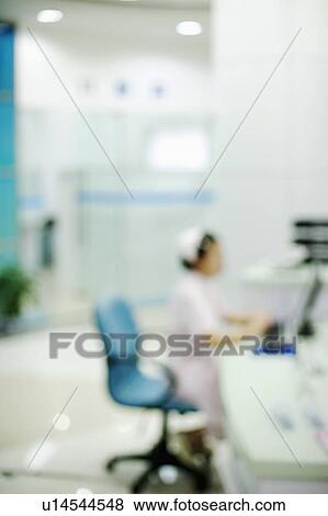 Side profile of a female nurse sitting on a chair View Large Photo Image Stock Photo - Side profile of a female nurse sitting on a chair. Fotosearch
