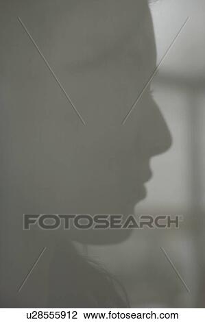 Silhouette of a woman's face behind a door View Large Photo Image Stock Image - Silhouette of a woman's face behind a door. Fotosearch