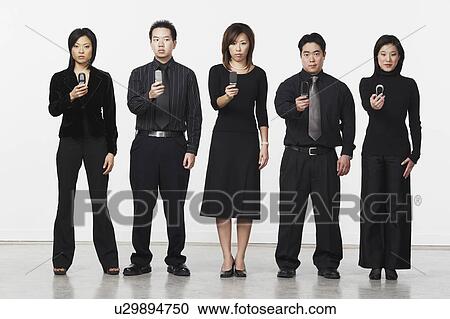 Three businesswomen and two businessmen holding mobile phones View Large Photo Image Stock Image - Three businesswomen and two businessmen holding mobile phones. Fotosearch
