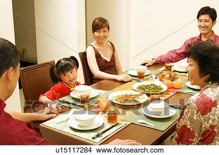 Picture - Three generation family sitting at the table. Fotosearch