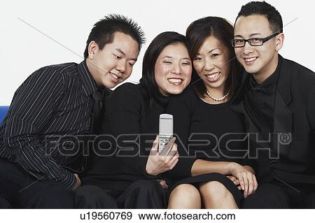 Two young men and two young women sitting on a couch View Large Photo Image Stock Photo - Two young men and two young women sitting on a couch. Fotosearch