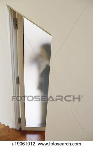Woman standing behind a door View Large Photo Image Stock Image - Woman standing behind a door. Fotosearch