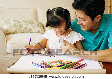 Stock Photo - Young man teaching his daughter to color. Fotosearch