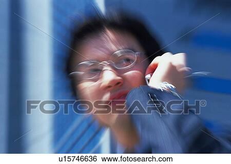 Stock Photograph - Bsinessman using mobile phone, Blurred Motion . Fotosearch