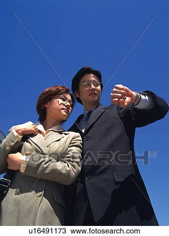 Businessman and businesswoman looking at the watch, Low Angle View View Large Photo Image Stock Image - Businessman and businesswoman looking at the watch, Low Angle View. Fotosearch