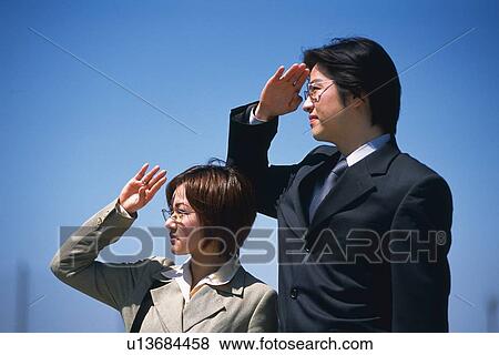 Businessman and businesswoman shading eyes with hands, Side View View Large Photo Image Stock Photo - Businessman and businesswoman shading eyes with hands, Side View. Fotosearch