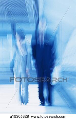Businessman and businesswoman standing, Blurred Motion, High Key View Large Photo Image Stock Photo - Businessman and businesswoman standing, Blurred Motion, High Key. Fotosearch