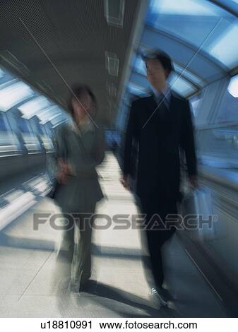 Businessman and businesswoman walking together, Blurred Motion View Large Photo Image Stock Image - Businessman and businesswoman walking together, Blurred Motion. Fotosearch
