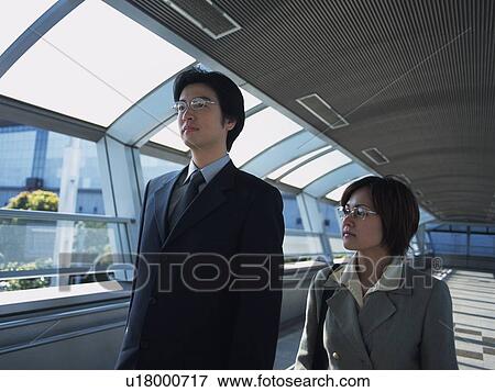 Businessman and businesswoman walking together, Side View View Large Photo Image Stock Photo - Businessman and businesswoman walking together, Side View. Fotosearch