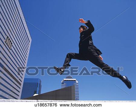 Businessman jumping and running, Low Angle View View Large Photo Image Stock Photograph - Businessman jumping and running, Low Angle View. Fotosearch