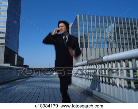 Stock Photo - Businessman running, Blurred Motion. Fotosearch