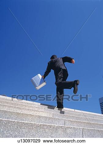 Businessman running up the stairs, Low Angle View View Large Photo Image Stock Photo - Businessman running up the stairs, Low Angle View. Fotosearch
