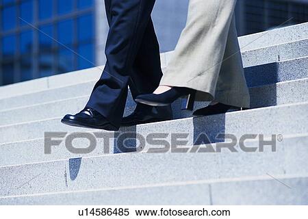 Feet walking down the stairs, Low Angle View View Large Photo Image Stock Photography - Feet walking down the stairs, Low Angle View. Fotosearch