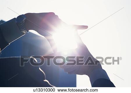 Stock Image - Fngers making frame, Lens Flare, Silhouette . Fotosearch