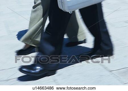 Stock Photograph - Walking feet, High Angle View, Blurred Motion. Fotosearch