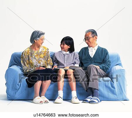 Senior adult man and woman sitting on a sofa with a granddaughter, Front View View Large Photo Image Stock Image - Senior adult man and woman sitting on a sofa with a granddaughter, Front View. Fotosearch