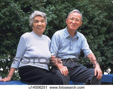 Senior adult man and woman sitting together on a bench, Front View View Large Photo Image Stock Image - Senior adult man and woman sitting together on a bench, Front View. Fotosearch