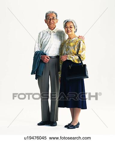Stock Photography - Senior adult man and woman standing together, Front View. Fotosearch